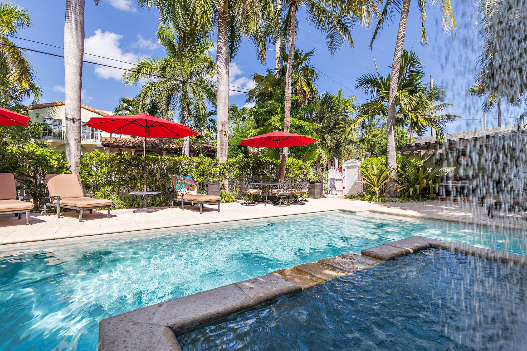 Image of chaises and red umbrellas overlooking the pool at Casa Grandview Bed and Breakfast